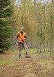 modern deer hunter standing in forest full length