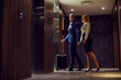 © Dusan Petkovic - Full length of middle-aged couple in formal wear entering the elevator in a hotel.