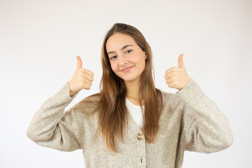 Young woman over isolated white background with thumbs up gesture and smiling