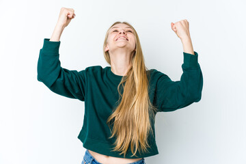 Wall Mural - Young blonde woman isolated on white background raising fist after a victory, winner concept.