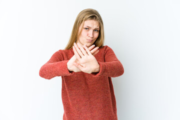 Wall Mural - Young blonde woman isolated on white background doing a denial gesture