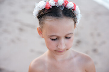 portrait of a little girl with dark hair and a hoop on her head. vacation and travel concept. summer