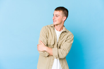 Young caucasian handsome man smiling confident with crossed arms.