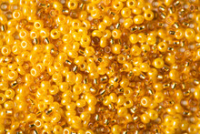 Closeup Top Above View Photo Of Shiny Shimmer Glowing Yellow And Golden Beads Background