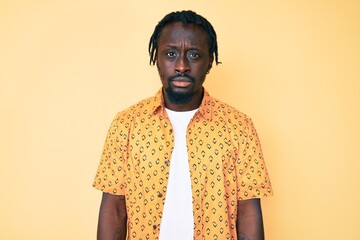 Poster - Young african american man with braids wearing casual clothes skeptic and nervous, frowning upset because of problem. negative person.