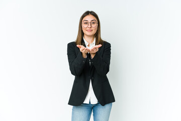 Young caucasian business woman holding something with palms, offering to camera.