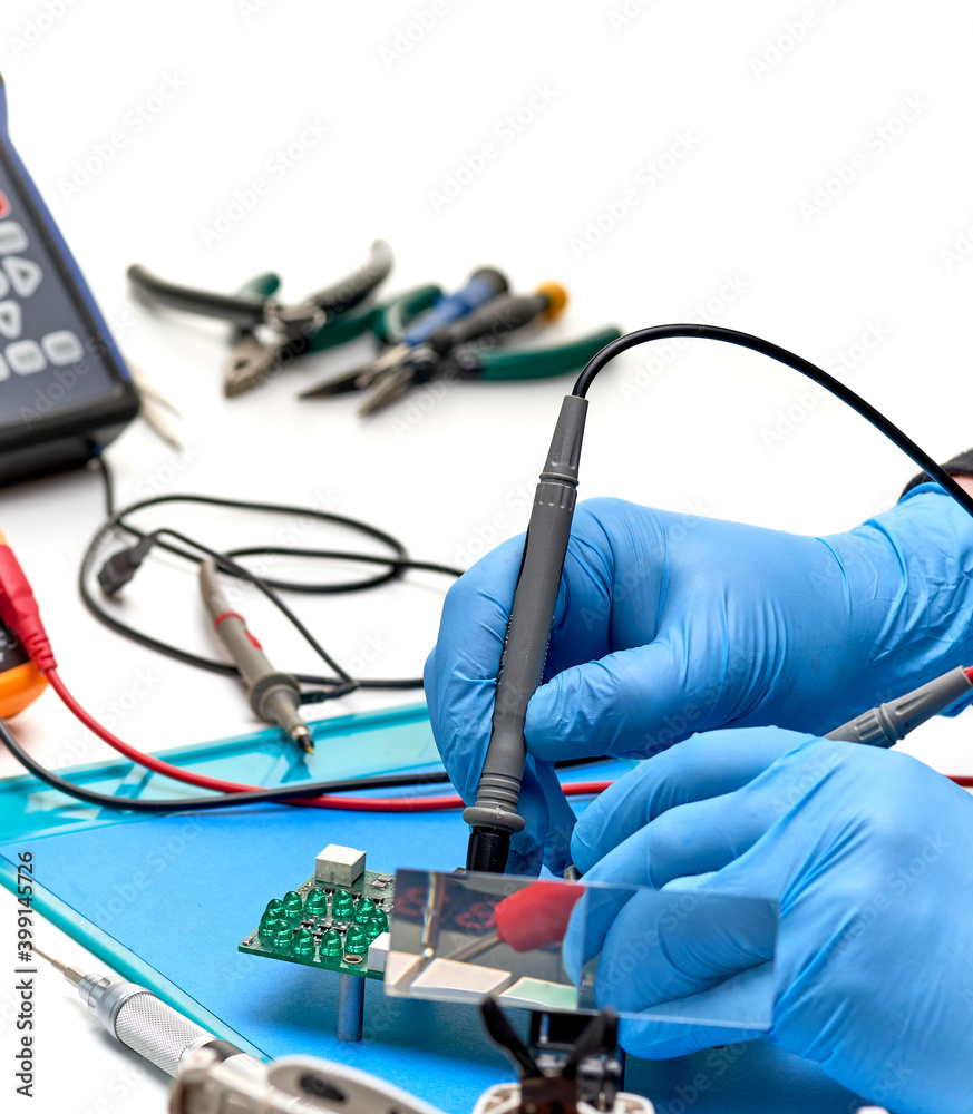 Electronics repair service-the master checks the electronic unit and ...