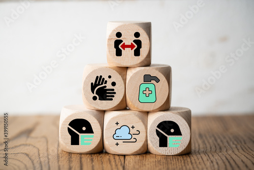 cubes with facemasks, soap and other info icons for good actions in a pandemic on wooden background