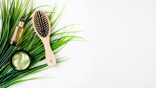 Eye Patches, Face Serum Bottle And Hair Brush On White Background Top View Mockup