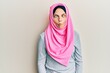 © Krakenimages.com - Young caucasian woman wearing traditional islamic hijab scarf making fish face with lips, crazy and comical gesture. funny expression.
