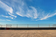 Metal barrier or railings between promenade and blue sky