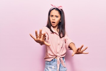 Sticker - Beautiful child girl wearing casual clothes doing stop gesture with hands palms, angry and frustration expression