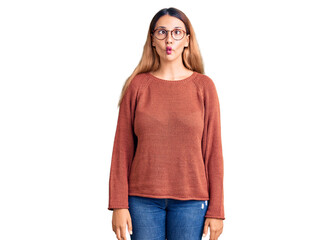 Canvas Print - Beautiful young woman wearing casual clothes and glasses making fish face with lips, crazy and comical gesture. funny expression.