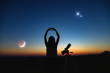 Wall Mural - woman looking at night sky with amateur astronomical telescope.