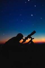 Wall Mural - woman looking at night sky with amateur astronomical telescope.