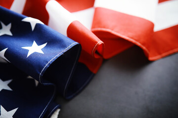 Flapping flag USA with wave. American flag for Memorial Day or 4th of July. Closeup of American flag dark background