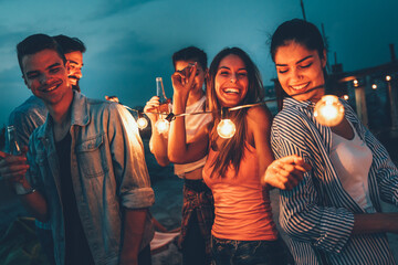 Wall Mural - Group of happy friends having party on rooftop