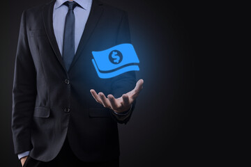 Businessman man holding money coin icon in his hands.Growing money concept for business investment and finance. USD or US dollar on dark tone background