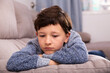 © JackF - Portrait of boy sitting on comfortable sofa in the lounge room. High quality photo