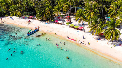 Aerial view of beautiful landscape, tourism boats, and people swimming on the sea and beach on May Rut island (a tranquil island with beautiful beach) in Phu Quoc, Kien Giang, Vietnam.