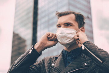 Wall Mural - man in a protective mask standing on a city street