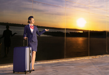 Canvas Print - Young stewardess with luggage outdoors