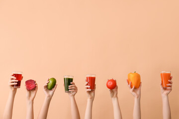 Many hands with glasses of vegetable juices on color background