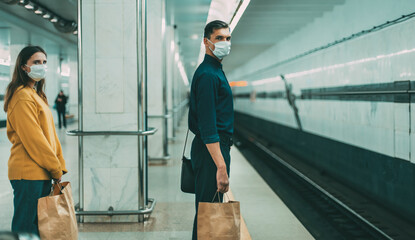 Wall Mural - passengers in protective masks waiting for the metro train