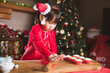 © M-image - young girl making Santa cupcake for Christmas party at home