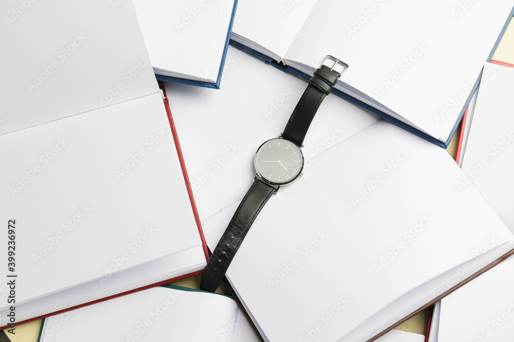 Wrist watch on open books