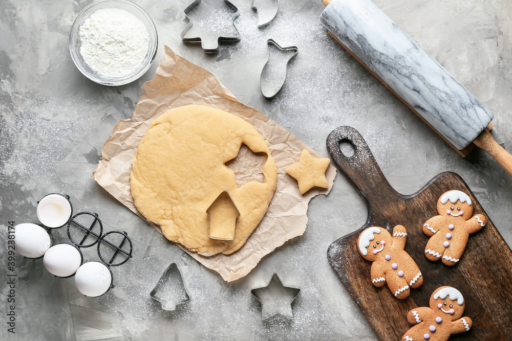 Fresh dough for gingerbread cookies and cutters on grunge background