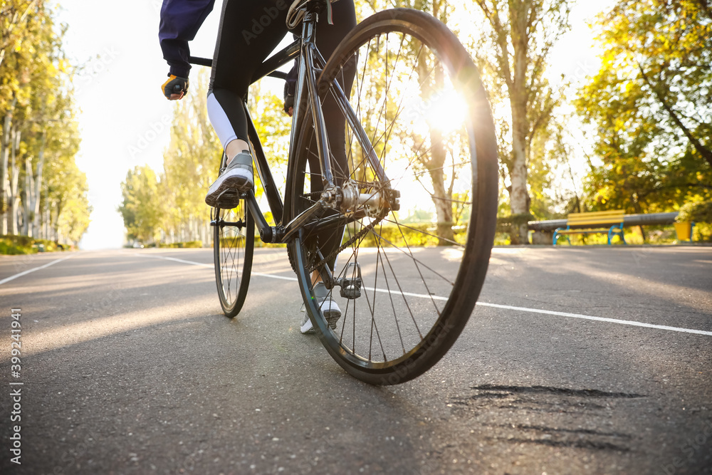 Female cyclist riding bicycle outdoors