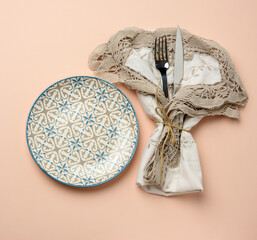 Wall Mural - empty round ceramic plate and metal fork and knife