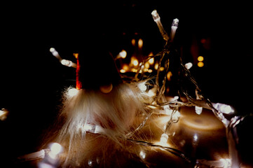 Christmas decorations hanging from a minimal white tree with lights