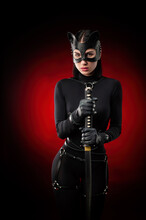 A Woman In A Black Body Belt And Cat Mask