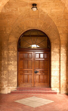 Wooden Door In Stone Arch.