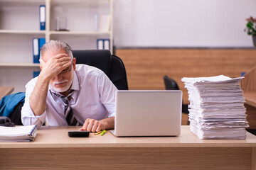 Old male employee unhappy with excessive work in the office