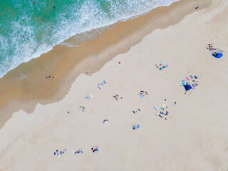 Wall Mural - High angle view of people sunbathing on beach