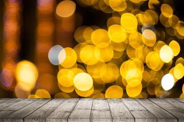 Wall Mural - blurred background of xmas tree lights and wall with table of brown color