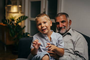 Wall Mural - boy with his grandfather playing at home