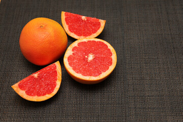 Fresh ripe red oranges on dark stone background. Top view with copy space