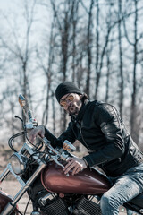 Wall Mural - Biker portrait. Photo with a motorcycle