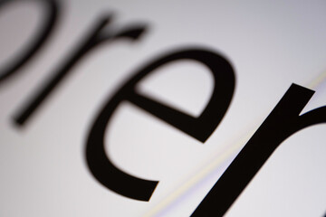 Poster - Close-up of part of black and white Lorem Ipsum text on a monitor screen with focus on the letter M at bottom right. Very narrow depth of field