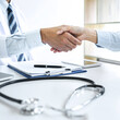 © Freedomz - Professional Male doctor in white coat shaking hand with female patient after successful recommend treatment methods, Medicine and health care concept