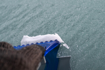 removing ice crystals with a plastic scraper