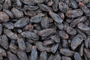 Wall Mural - black raisins closeup texture background