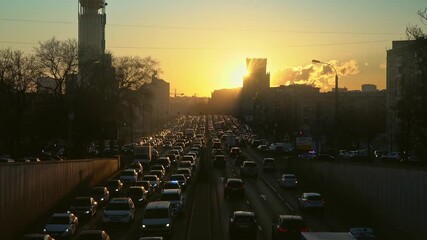 Wall Mural - Traffic on the urban street  at sunset