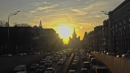 Wall Mural - Traffic on the urban street  at sunset