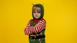 © Andrii Iemelianenko - Side view shocked blonde kid girl in Christmas elf Santa helper costume. Child turn round look at camera and say ask question what isolated on yellow background. People sincere emotions