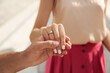 © New Africa - Lovely couple with beautiful ring after engagement outdoors, closeup